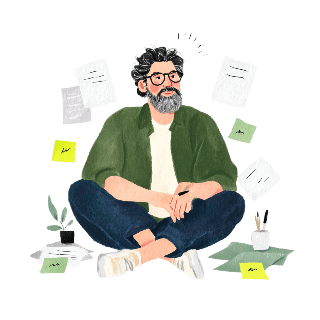 Carlos seduto a gambe incrociate tra fogli e post-it, penna in mano